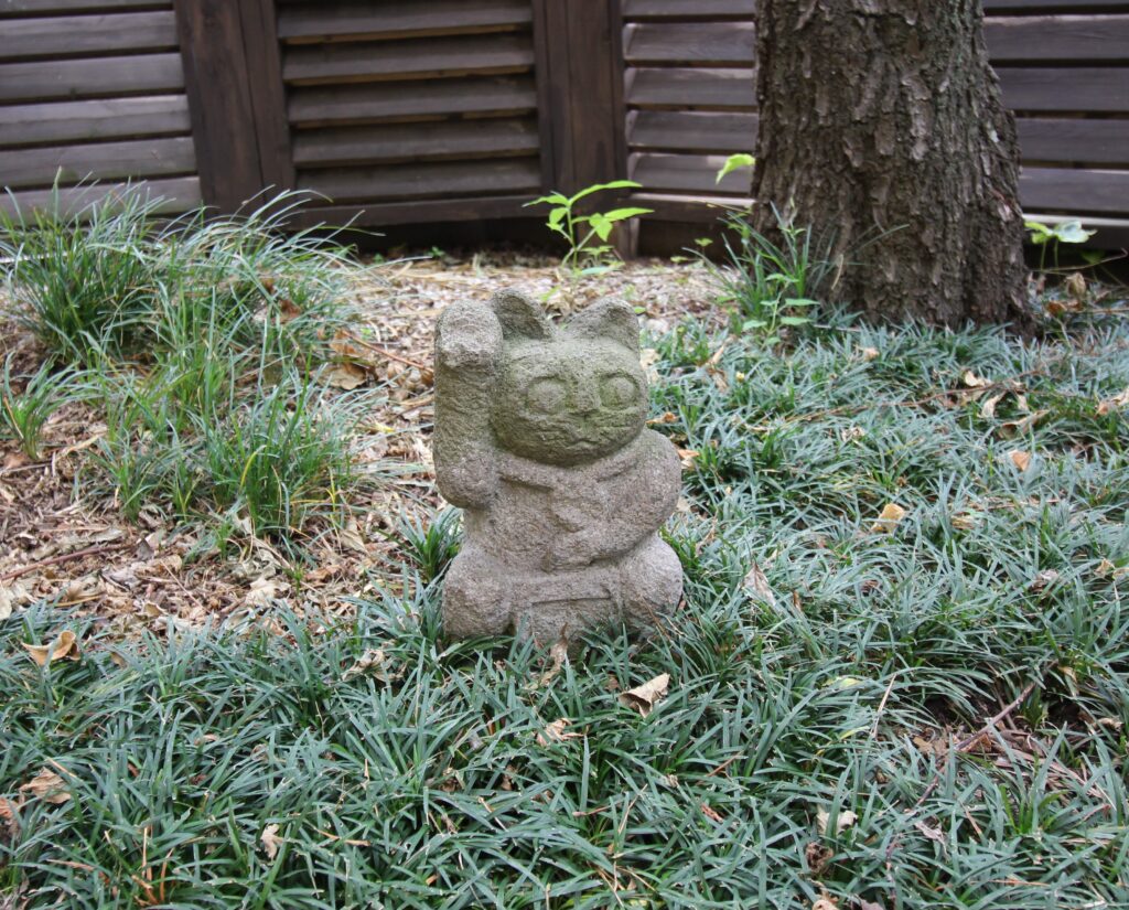 ウッドフェンス前の猫の石像　調布市